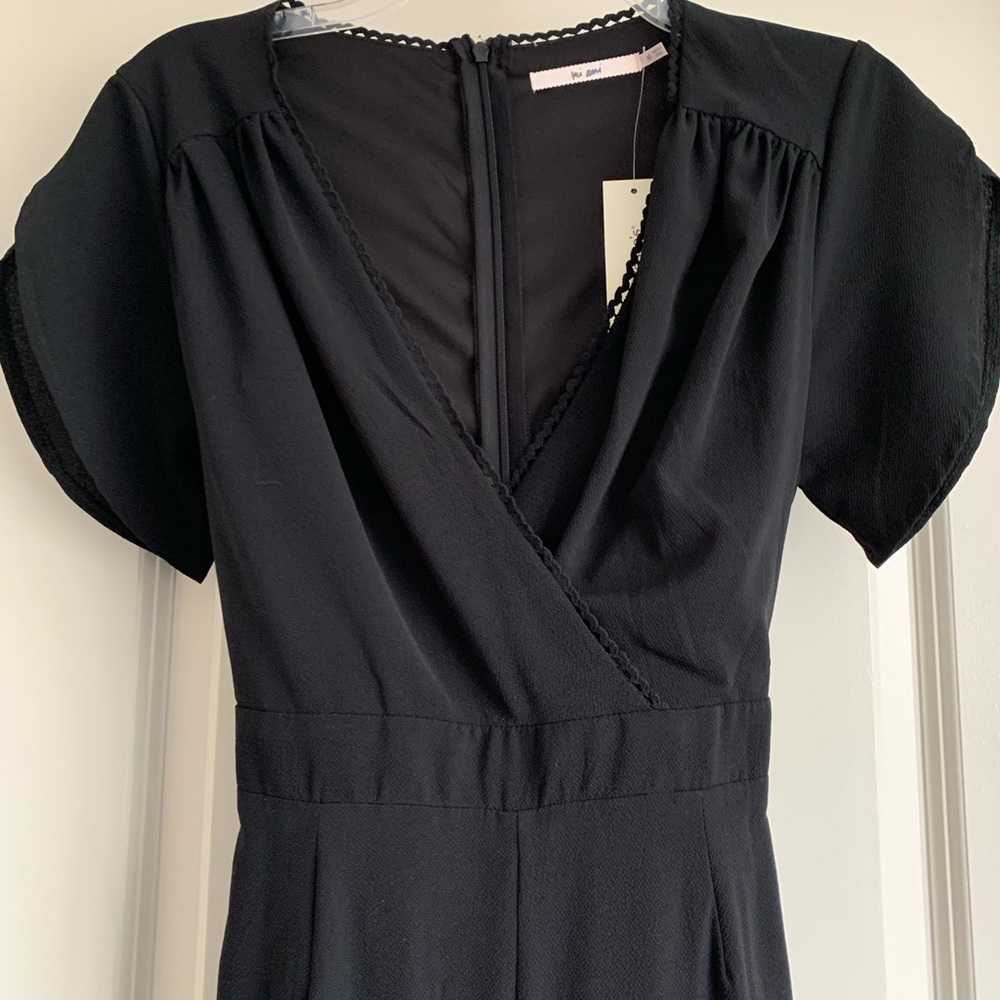 Black short sleeved romper with tie around waist